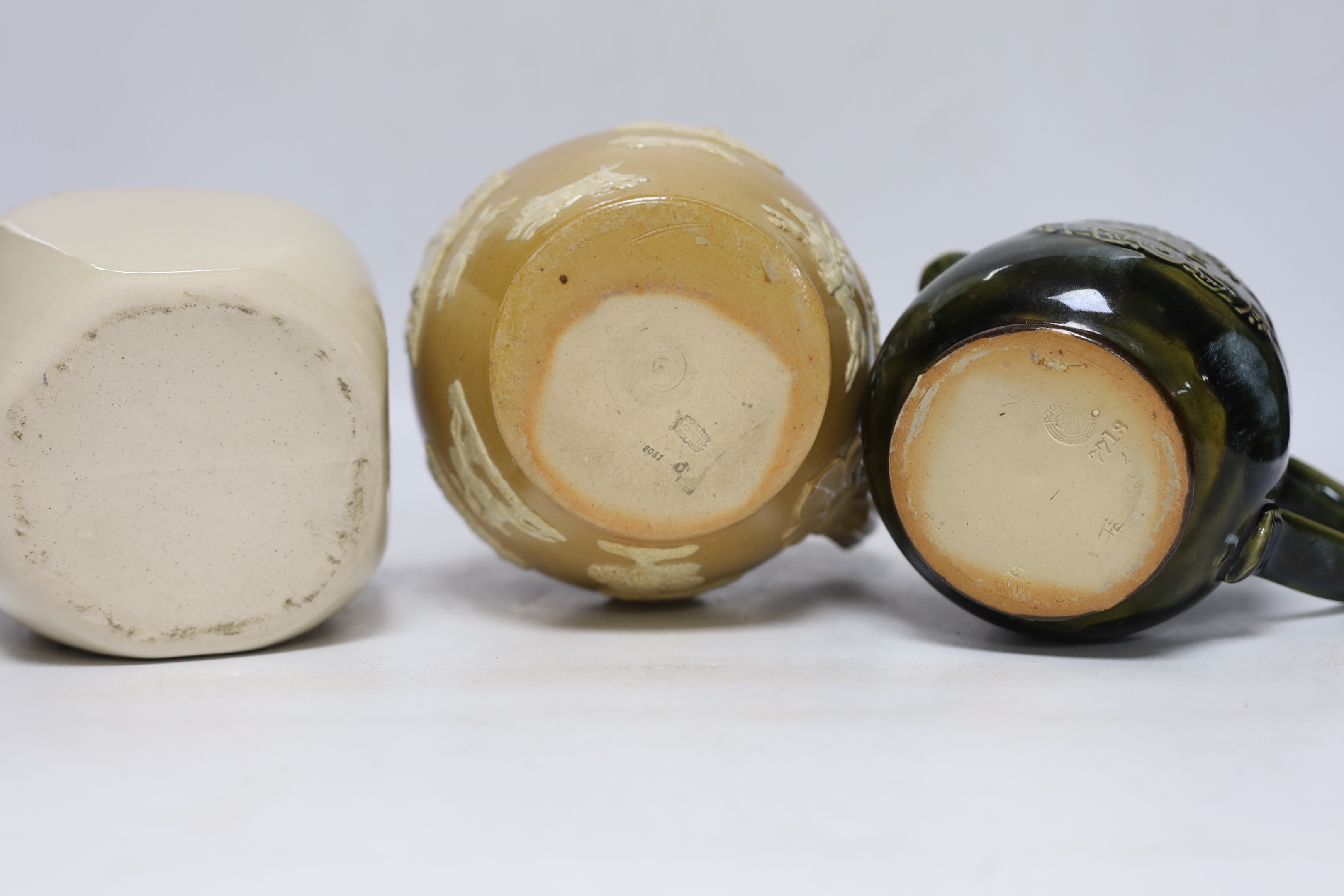 Three Thoune glazed earthenware items comprising dish, jug and vase, two signed to the base, the largest 12cm wide, Two Doulton stoneware jugs and a Long John whisky ewer, largest 17cm high